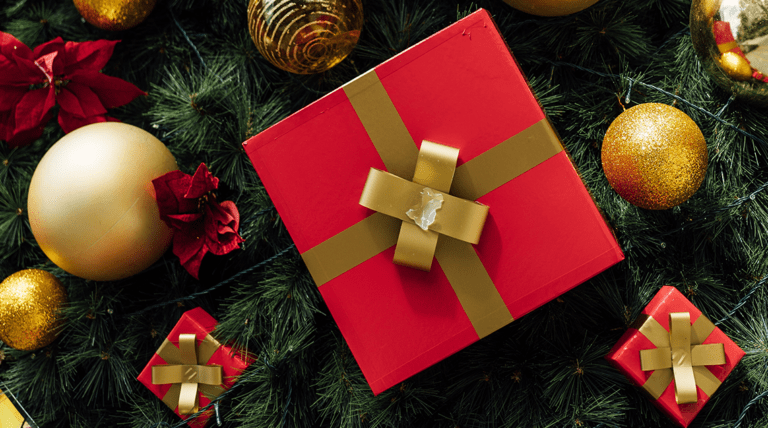 red Christmas present surrounded by gold baubles and smaller red presents stuck onto a tree